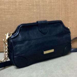 SHIH Black leather purse with gold hardware.